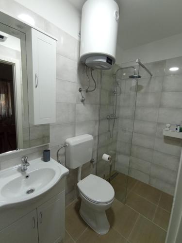 a bathroom with a toilet and a sink and a shower at Luce in Kijevo
