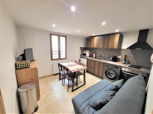 un salon avec un canapé bleu et une table dans l'établissement Joli T2 1er étage wifi/verdon/centre ville, à Castellane