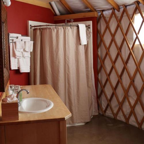 a bathroom with a shower curtain and a sink at Sagecliffe Resort & Spa in George
