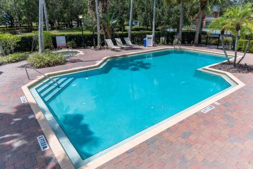 a large blue swimming pool with chairs around it at Legacy Vacation Resorts - Disney and Lake Buena Vista in Orlando