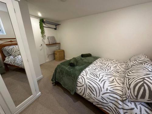 a bedroom with a zebra print bed in a room at Cozy 1 Bedroom Flat The Snug in Kent