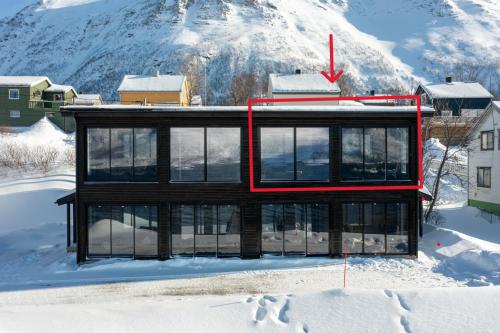 a house on top of a snow covered mountain at Skipperhuset leilighet nr 1 in Tofta