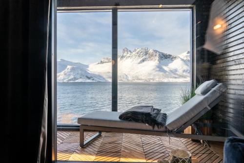a view of the snow covered mountains from a window at Skipperhuset leilighet nr 1 in Tofta