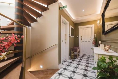 a hallway with a black and white tiled floor at Zebbuga Tranquil Suite with Balcony 5 in Żebbuġ