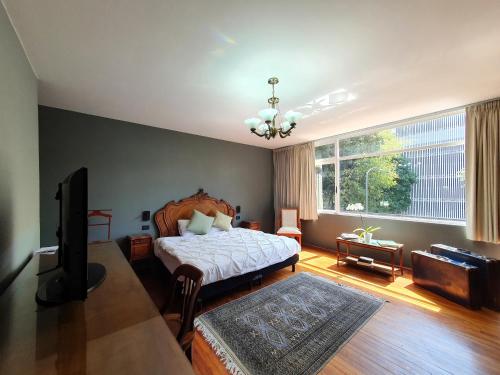 a bedroom with a bed and a television in it at Lindas Suites Eugenio Sue in Mexico City