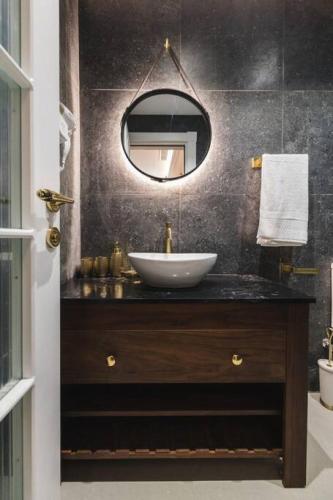a bathroom with a sink and a mirror at Zebbuga Lavish Suite 2 in Żebbuġ