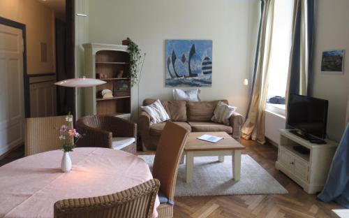 a living room with a couch and a table at An der Aue in Klütz