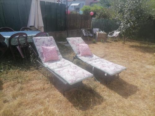deux bancs assis dans l'herbe dans une arrière-cour dans l'établissement Maison du soleil, à Prades