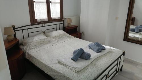 a bedroom with a bed with two towels on it at Under the Castle - In the heart of the Old Town in Naxos Chora