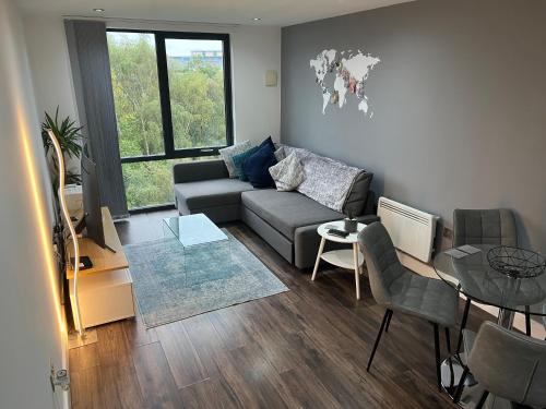 a living room with a couch and a table at Perfect-City Centre-Apartment in Birmingham