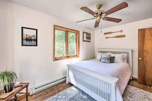 a bedroom with a bed and a ceiling fan at Peaceful Pond family fun getaway in Albrightsville