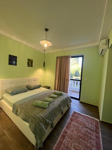 a bedroom with a large bed and a large window at Hotel Florida in Durrës