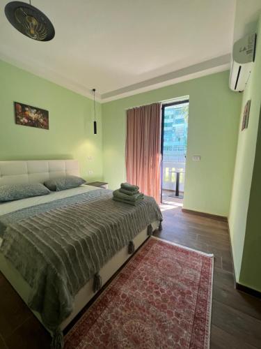 a bedroom with a bed and a large window at Hotel Florida in Durrës