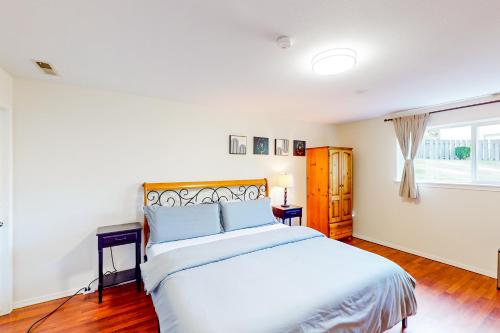 a bedroom with a large white bed and a window at The Renton Rest House in Renton