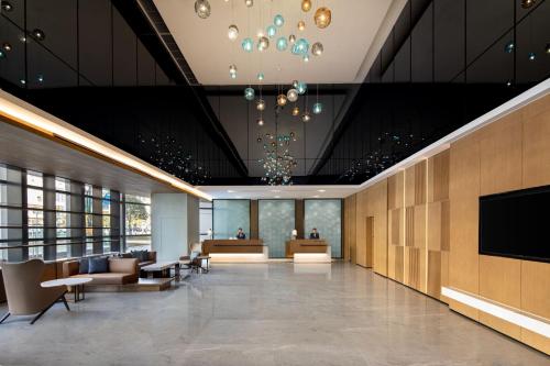 um lobby de um hotel com sofás e uma tv em Fairfield by Marriott Chongqing Yongchuan em Chongqing