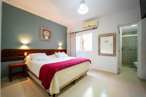 a bedroom with a large bed and a window at Pousada da Praia in Paraty