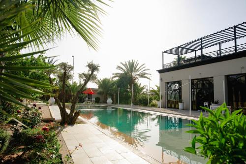 a swimming pool in front of a building at Palace Jena in Marrakech