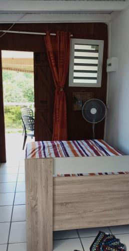 a bed in a room with a window at Weston in Deshaies
