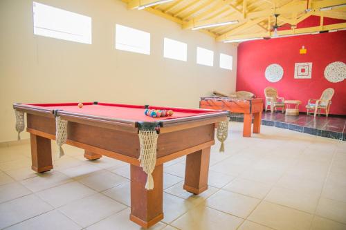 a pool table in the middle of a room at Paramar in Ubatuba