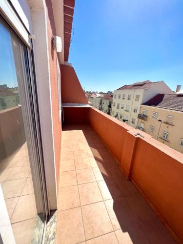 a balcony with a view of a building at Estrela de Almada in Almada
