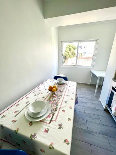 a room with a table with a table cloth on it at Estrela de Almada in Almada
