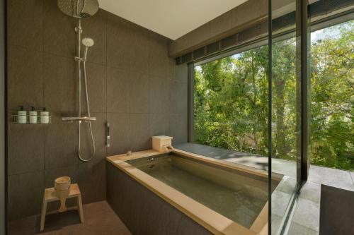a bathroom with a tub and a large window at Shisui, a Luxury Collection Hotel, Nara in Nara