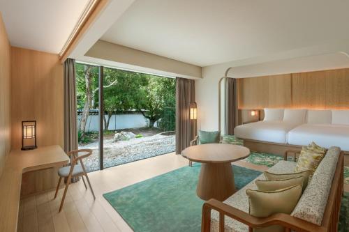 奈良市にあるShisui, a Luxury Collection Hotel, Naraのベッドとテーブルが備わるホテルルームです。