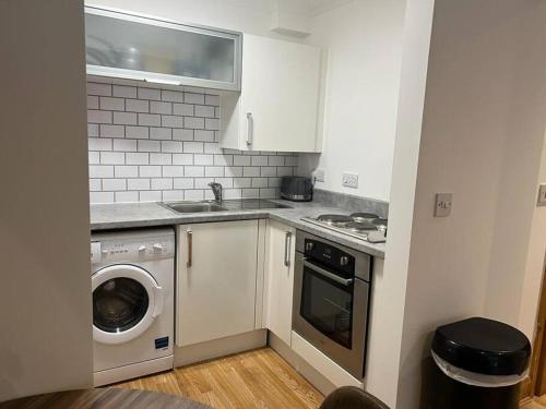 a kitchen with a washing machine and a washer at Apt 1 prime central Location close cathedral in Norwich