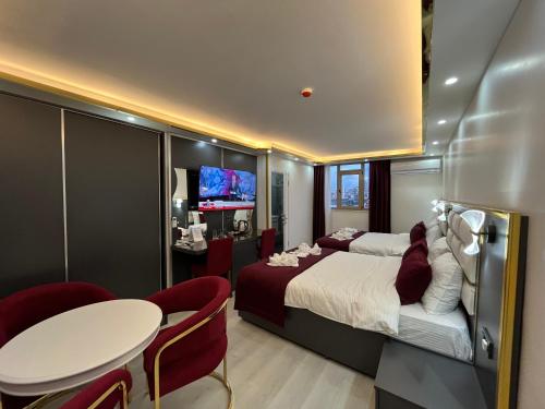 Lale Sultan Hotel في إسطنبول: غرفة فندقية بسرير وطاولة وكراسي