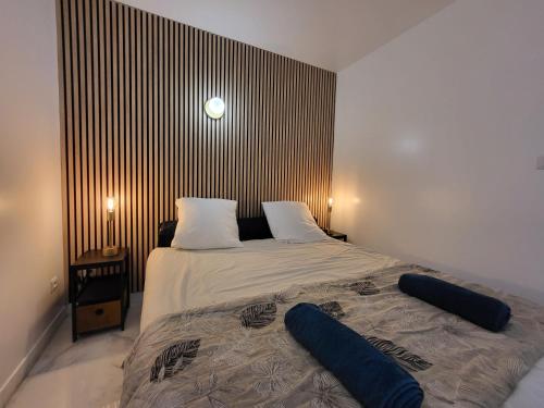 a bedroom with a bed with two pillows on it at Le Bellevue - Beaux appartements avec vue splendide in Palaiseau