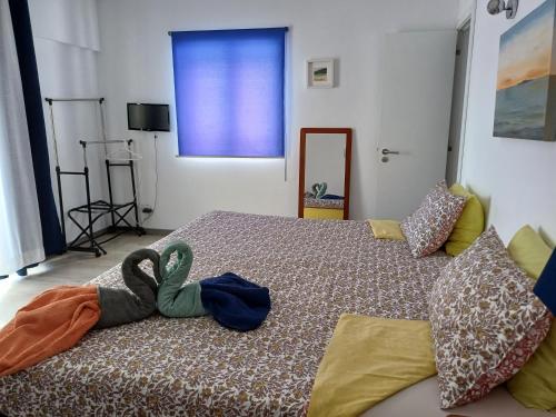 a bedroom with a bed with towels on it at Guest House Casa Ramos on the Strip in Albufeira
