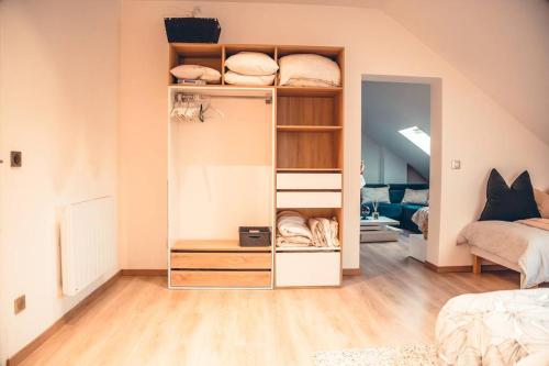 Habitación con estantería blanca con almohadas en Les temps heureux, en Dunkerque