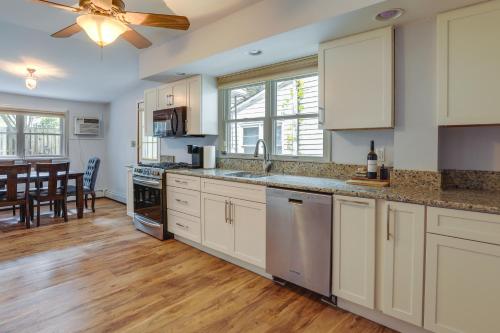 a kitchen with white cabinets and a ceiling fan at Centrally Located New Jersey Home with Private Yard in Lambertville