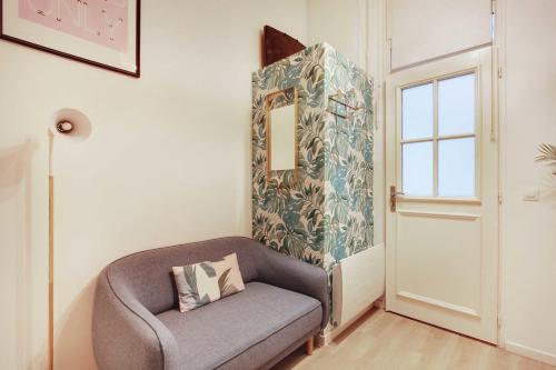 a chair in a room with a mirror at Beautiful apartment 2P - Rue de l'Université Near Invalides in Paris