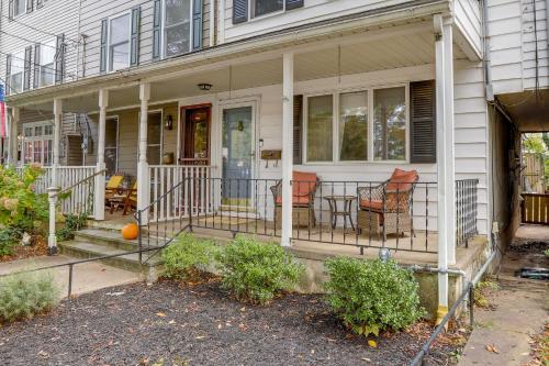 a house with a porch with two chairs and a table at Centrally Located New Jersey Home with Private Yard in Lambertville