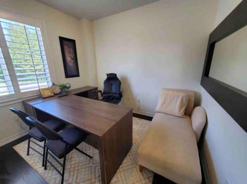 a living room with a desk and a couch at Modern & Cozy Kawartha Getaway in Kawartha Lakes