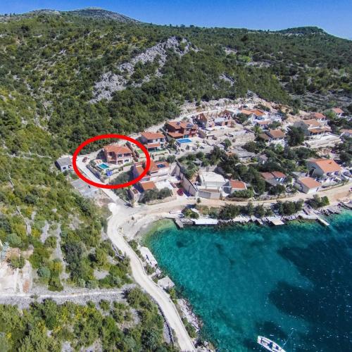 an aerial view of a villa with a red house at Villa Kamelicina in Vinišće