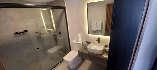 y baño con ducha, aseo y lavamanos. en Casa Tlaxcalli by Beddo Hoteles en Tlaxcala de Xicohténcatl