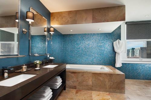 a bathroom with a tub and a sink at The US Grant, a Luxury Collection Hotel, San Diego in San Diego