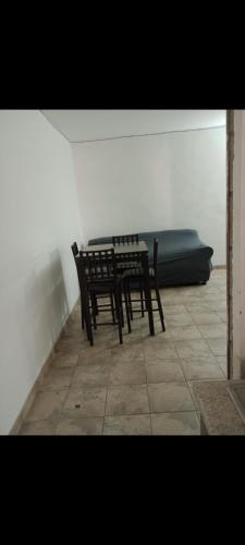 a table and chairs in a room with a couch at Media luna in Ciudad Juárez