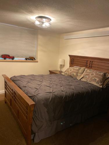 een slaapkamer met een groot bed met een houten hoofdeinde bij Del Boca Vista in Owatonna