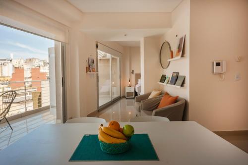 a bowl of fruit on a table in a living room at Báltico Suites in Buenos Aires
