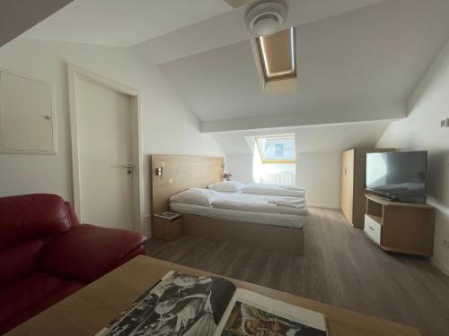 a hotel room with a bed and a flat screen tv at Eurotel am Main in Offenbach