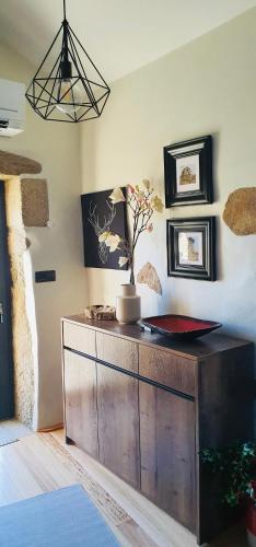 a wooden cabinet with a vase on it in a room at Casa Fina in São Pedro do Sul