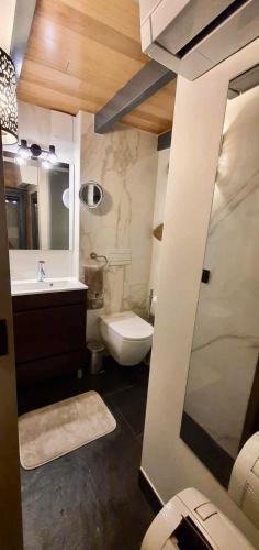 a bathroom with a sink and a toilet and a mirror at Casa Fina in São Pedro do Sul