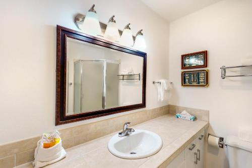 a bathroom with a sink and a mirror at Down By The Bay #C202 in Newport