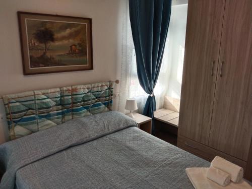 a bedroom with a bed and a window at ANGI B&B in Budrio
