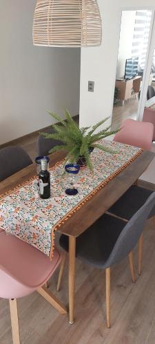 a dining room table with a potted plant on it at Hermoso departamento in Iquique