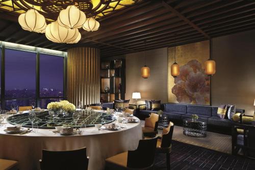 a dining room with a large table and chairs at The Ritz-Carlton, Chengdu in Chengdu
