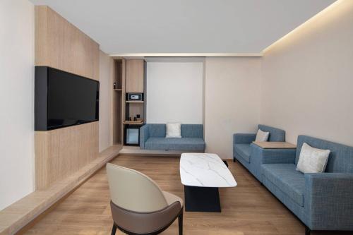 a living room with a couch and a tv at Fairfield by Marriott Beijing Haidian in Beijing